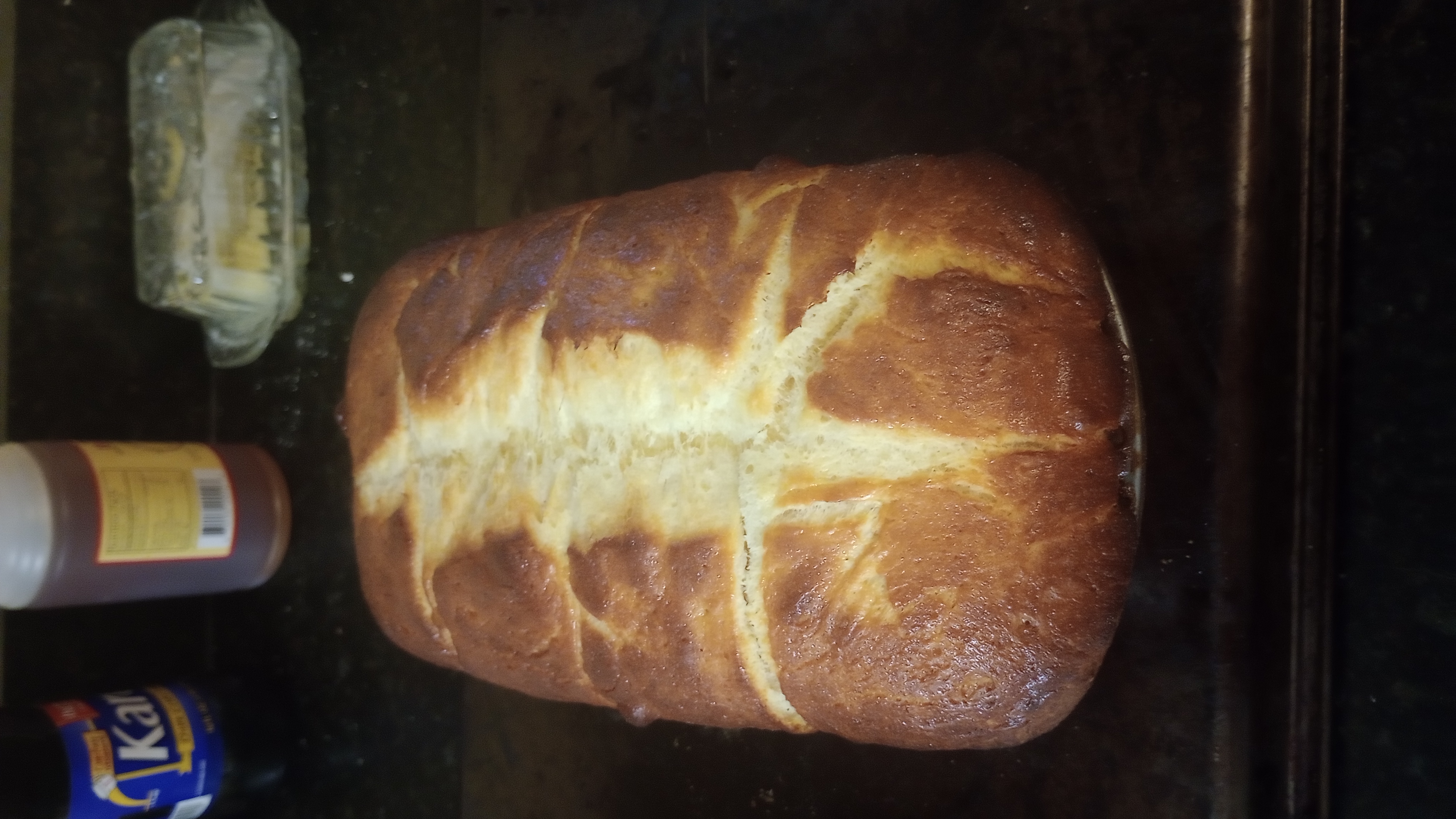 a shiny golden brown loaf of fresh baked brioche bread
