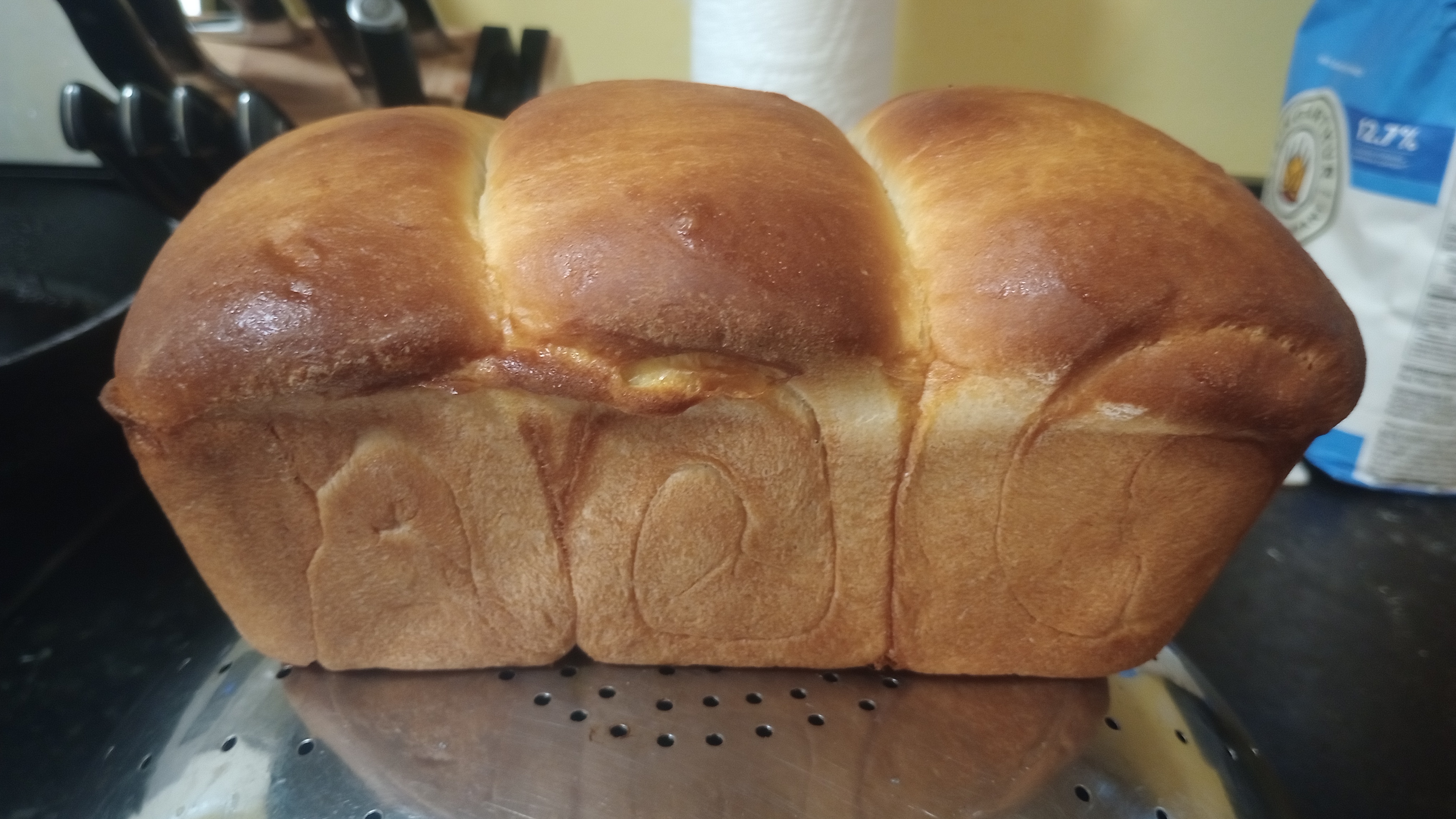spirals in the side of a fresh golden brown loaf of shokupan