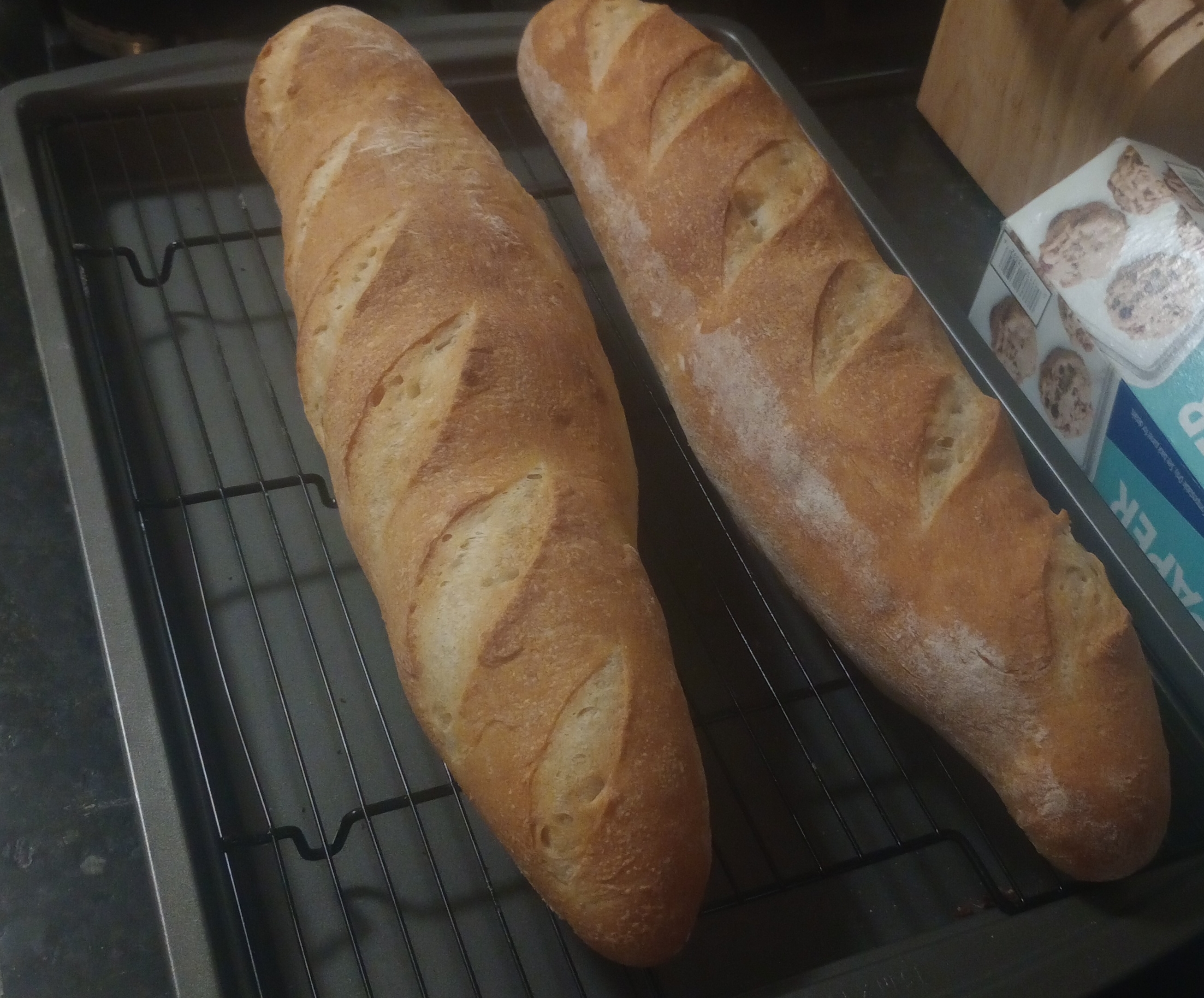fresh baked french baguettes with score marks.